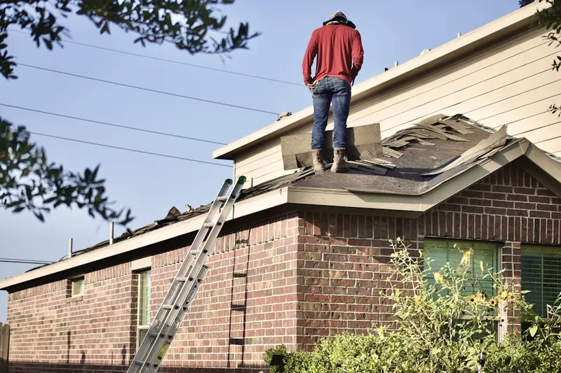 Professional roofer working on a residential roof in Green Knoll
